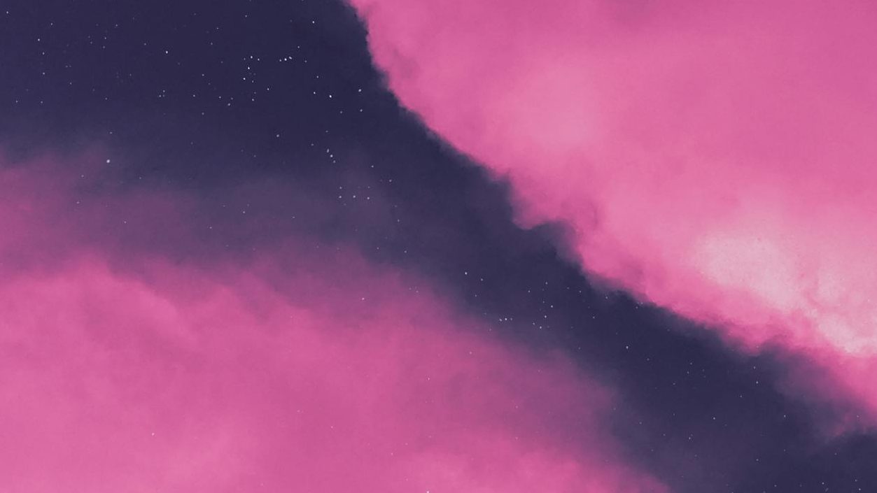 An abstract image depicting swirling masses of vivid pink cloud-like formations against a dark, star-speckled background. A diagonal dark band with subtle stars cuts through the pink.